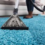 person using an at home carpet cleaner